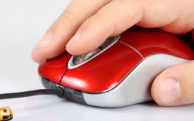 A hand operating a computer mouse